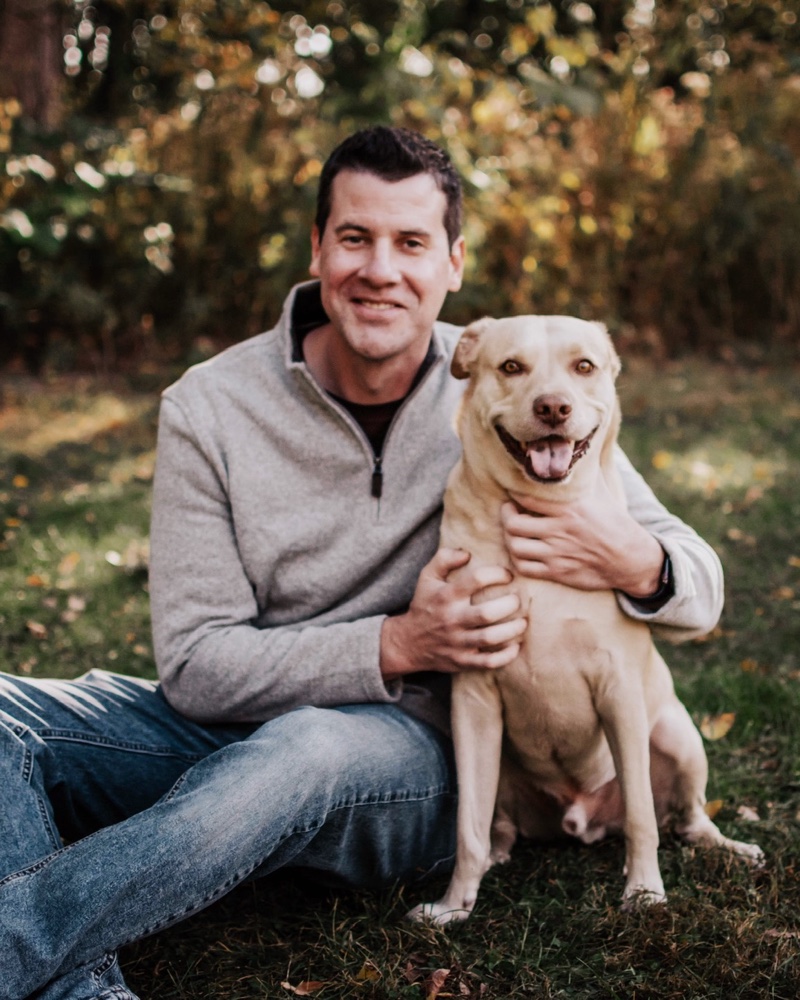 Christopher Ducey with his dog outdoors
